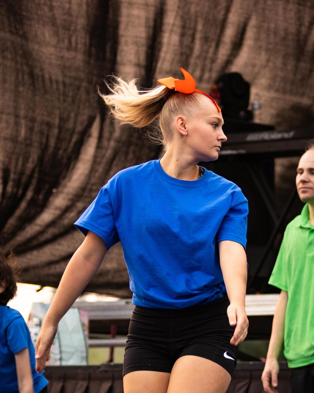 A teenage girl focusing on her next landing point during a dance performance at a competition.